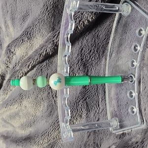 Handmade decorative Dinosaur beaded pen. Includes pouch.